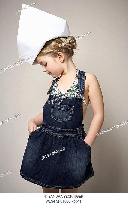 Fashionable little girl wearing big paper hat
