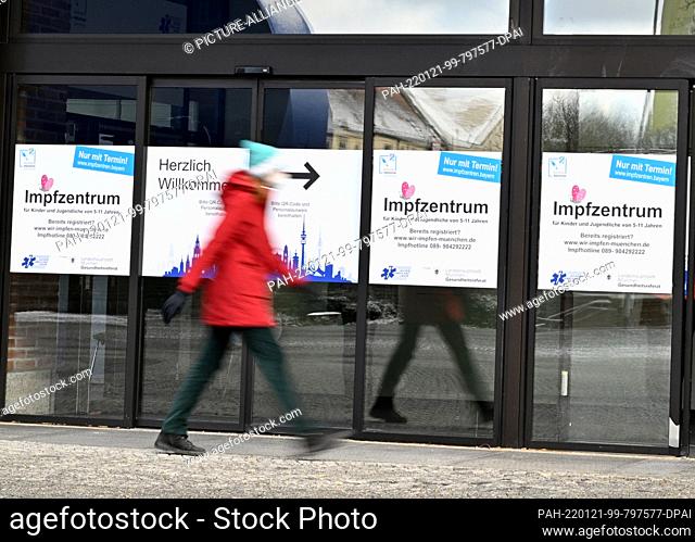 21 January 2022, Bavaria, Munich: A passerby walks past a corona vaccination center housed in the Gasteig. Photo: Peter Kneffel/dpa