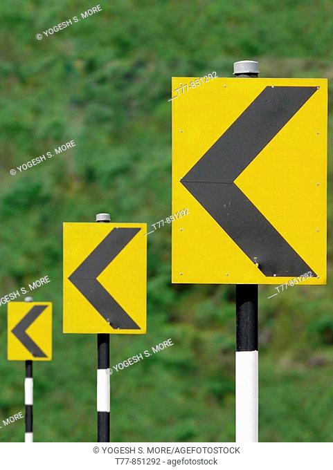 Road sign boards in sequence showing turning driving directions Katraj Bipass Highway, Pune, Maharashtra, India