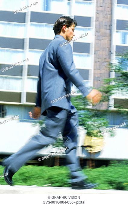 Young businessman running