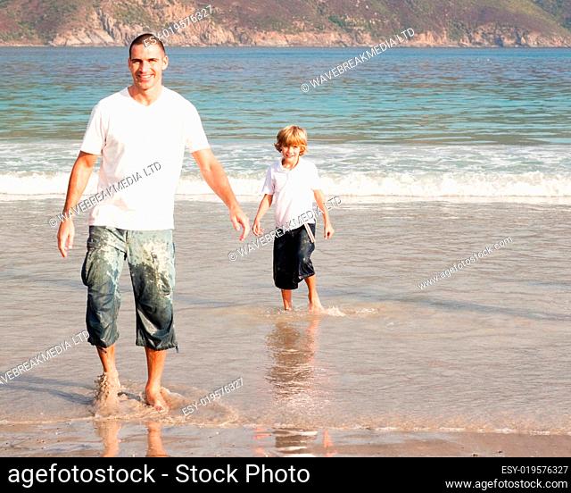 Father and son playing on a beach