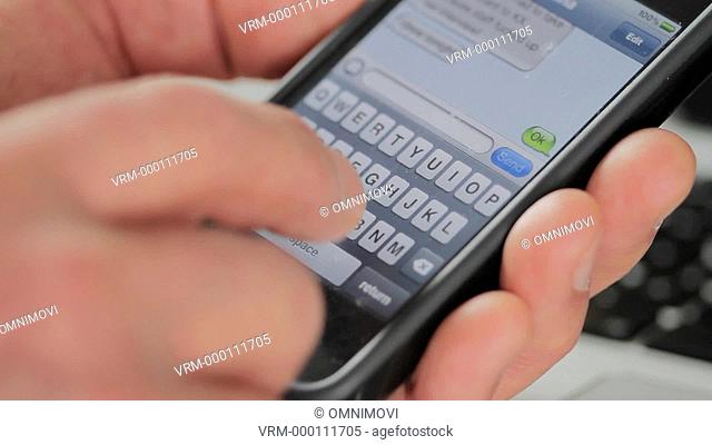 Person Typing Text Message with Smart Phone
