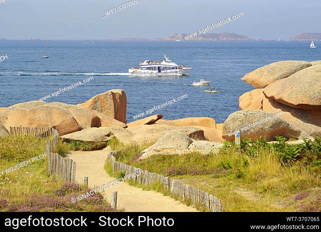 A cruise ship and rocks on the Pink Granite Coast, Brittany, France (Côte de Granit Rose)