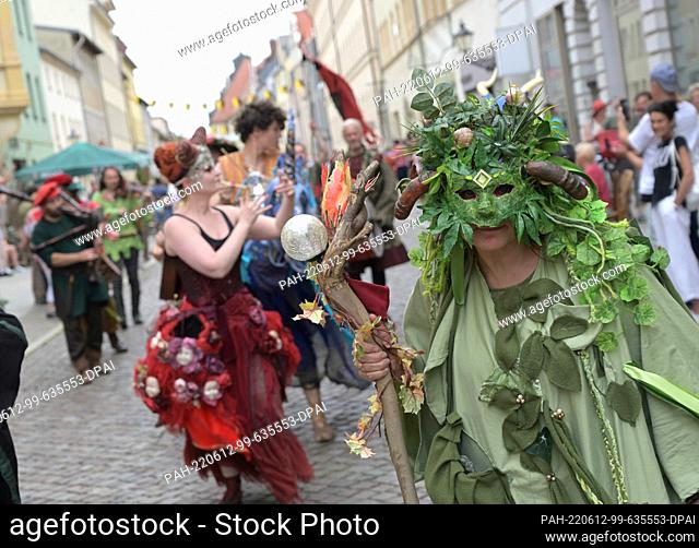11 June 2022, Saxony-Anhalt, Wittenberg: Performers of mythical creatures are present at the historical parade for ""Luther's Wedding""