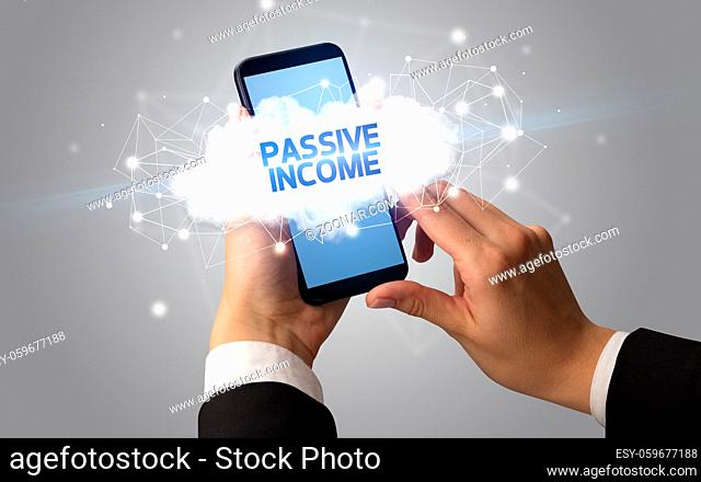 Female hand touching smartphone with PASSIVE INCOME inscription, cloud business concept