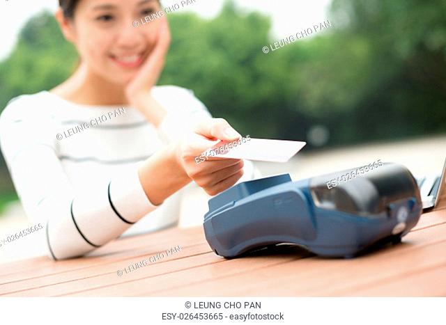 Woman using credit crad to pay