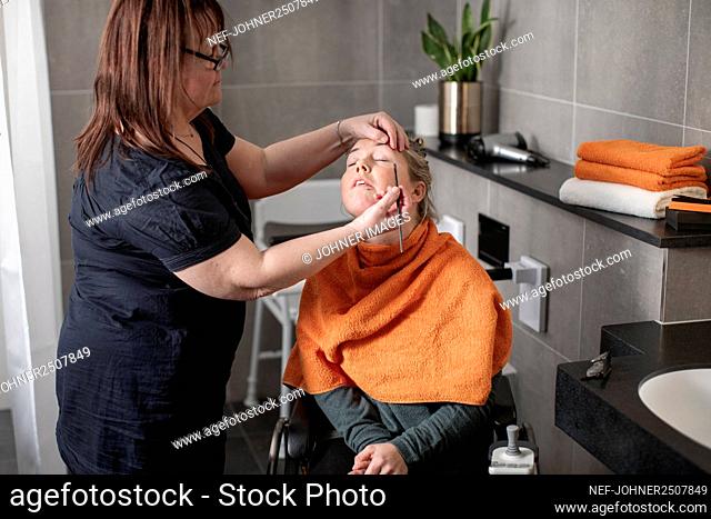 Woman having her make up done