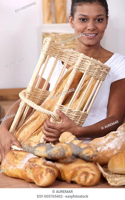 Woman in a bakery with a basket of bread