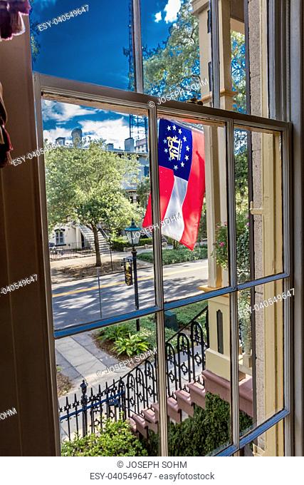 JUNE 28, 2017 - Historic Hamilton-Turner B&B in Savannah Georgia features Georgia State Flag through window
