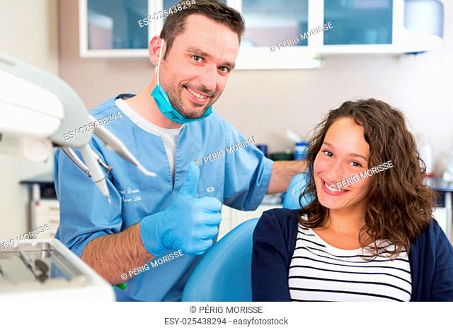 View of a Young attractive dentist explaning his work to a patient