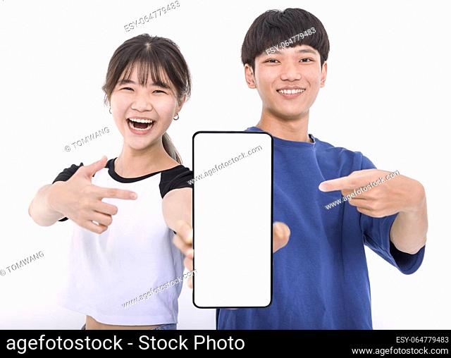 Happy Asian teenager students holding smartphone mockup of blank screen