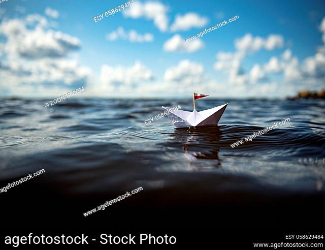 Paper boat in big waves
