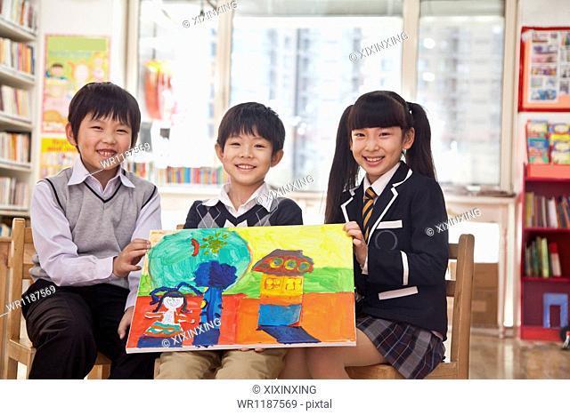 Portrait of three students with a painting