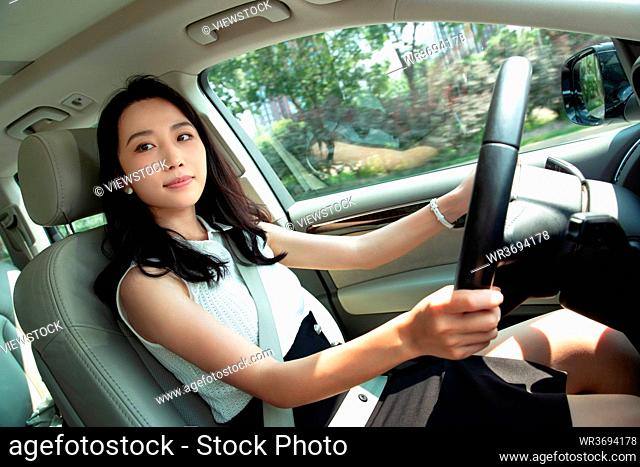 A beautiful young woman driving