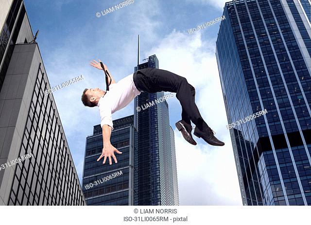 Businessman high jumping