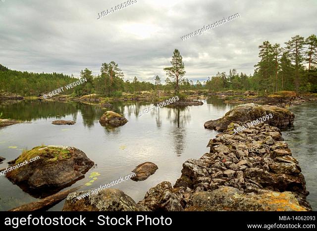 lake, rock and forest landscape in sweden