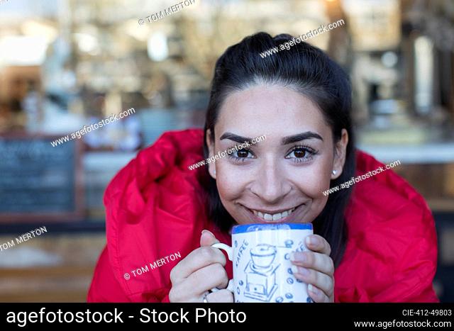 Close up portrait happy young woman drinking coffee