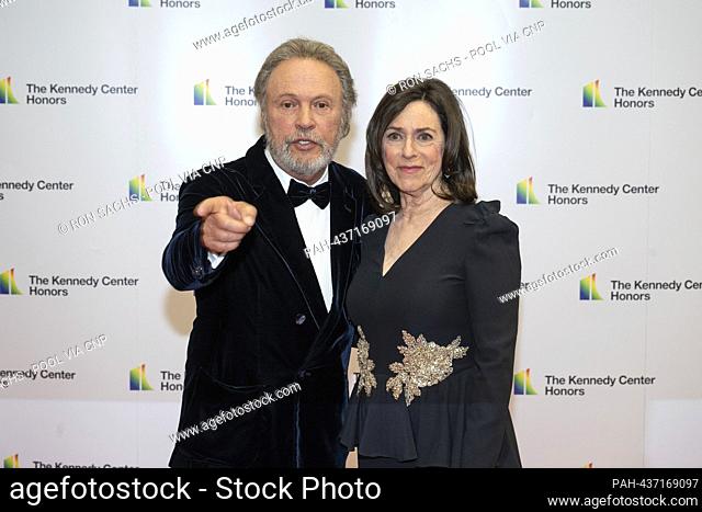 Billy Crystal points towards the photographers as he and his wife, Janice Crystal arrive for the Medallion Ceremony honoring the recipients of the 46th Annual...