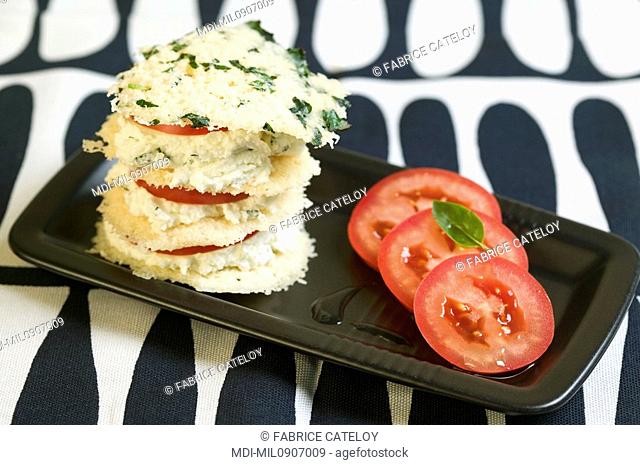 Millefeuille with tuiles of parmigiano reggiano, tomatoes and fresh goat's cheese