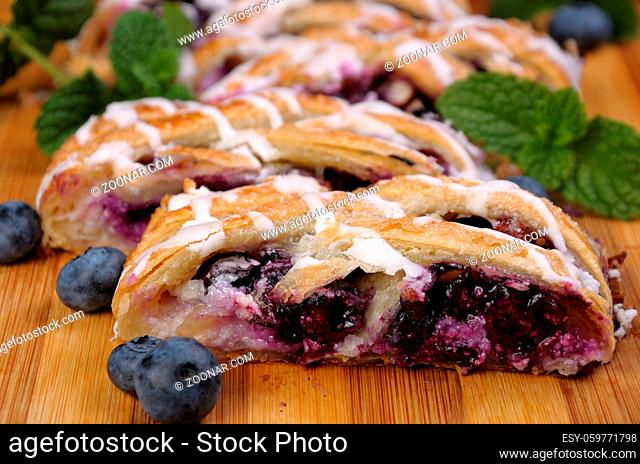 Pie stuffed with cheese cream , blueberry, crushed peanuts dough braided plait