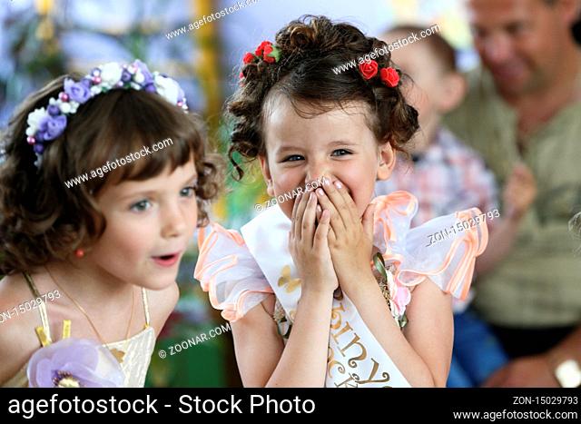 Joyful girl at the party laughs cheerfully.Joyful graduates of a kindergarten