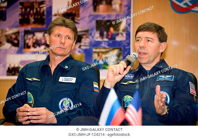 Expedition 19 Commander Gennady I. Padalka, left, and Flight Engineer Michael R. Barratt answer questions from behind glass during a press conference on...