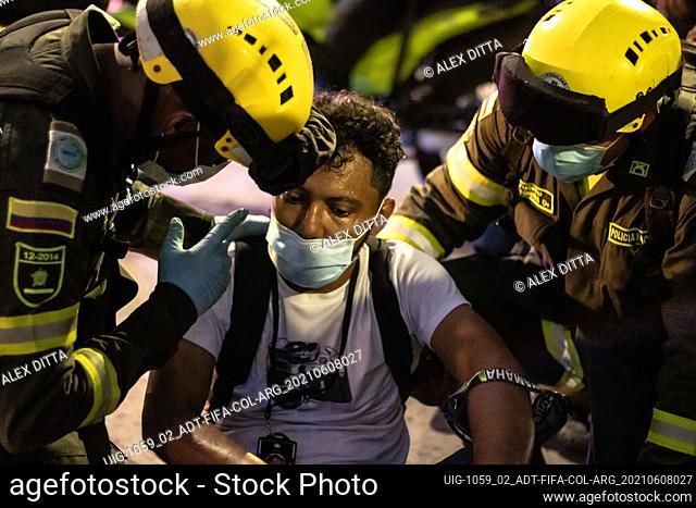 A member of the press is asisted by rescue police after clashes as the Colombian and Argentina teams played a qualifying match for FIFA Quatar World Cup 2022 at...