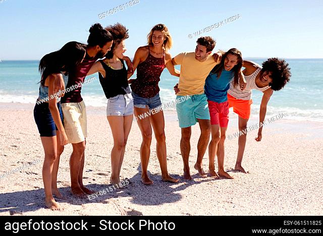 Multi-ethnic group of male and female standing on the beach