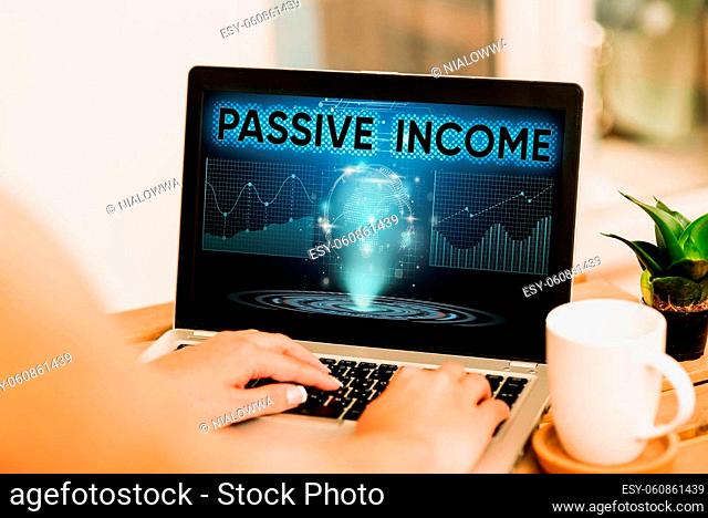 Text showing inspiration Passive Income, Concept meaning earnings extracted from rental property, and other enterprises Hand Typing On Laptop Next To Coffee Mug...