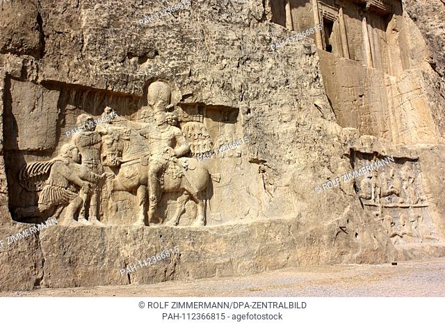 Iran - Naqsh-e Rostam, rock relief, shows Shapur I, triumphant over the two defeated Roman emperors Valerian (kneeling) and Philip of Arabs, Fars province