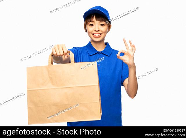 delivery woman with paper bag showing ok sign