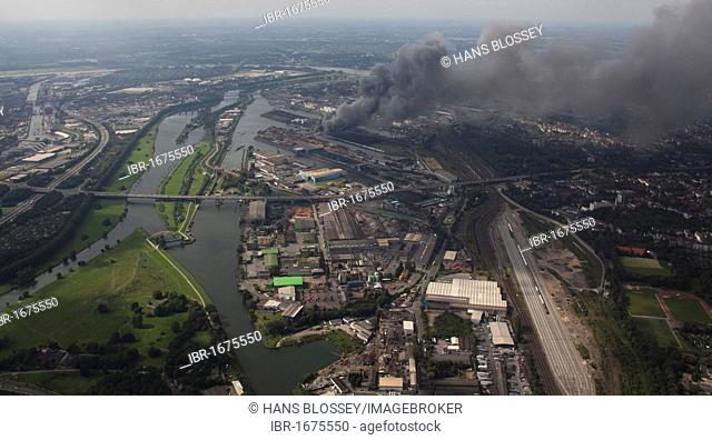 Aerial view, smoke, fire on a scrap island in the Duisport inland port, Duisburg, Ruhrgebiet region, North Rhine-Westphalia, Germany, Europe