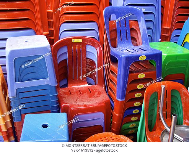 Coloured plastic chairs and stools at Kampot market, Cambodia