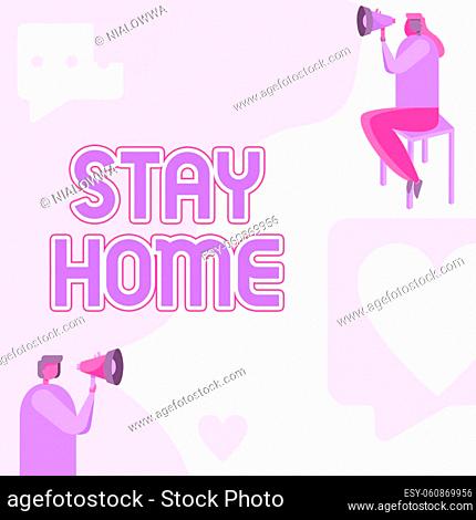 Text sign showing Stay Home, Conceptual photo not go out for an activity and stay inside the house or home Man Standing And Woman Sitting Both Holding Megaphone...
