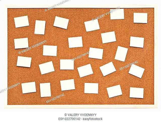 many small sheets of paper on bulletin cork board