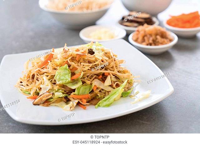fried noodles on plate with ingredients