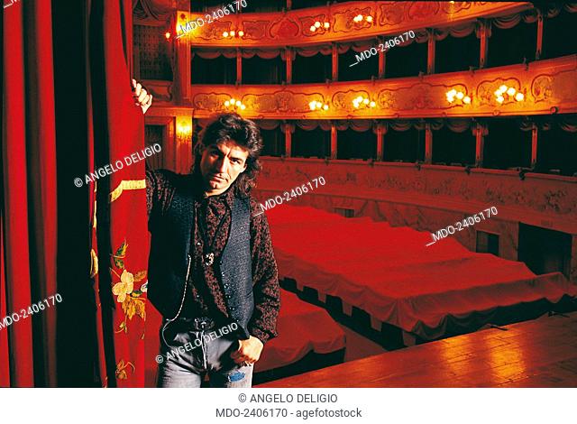 Italian singer-songwriter Luciano Ligabue (Luciano Riccardo Ligabue) posing at the Theatre Asioli leaning a hand on the curtain in a photocall shooted in his...