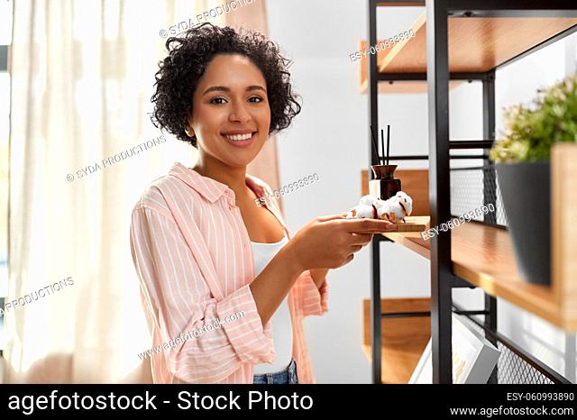 woman with aroma reed diffuser and cotton at home