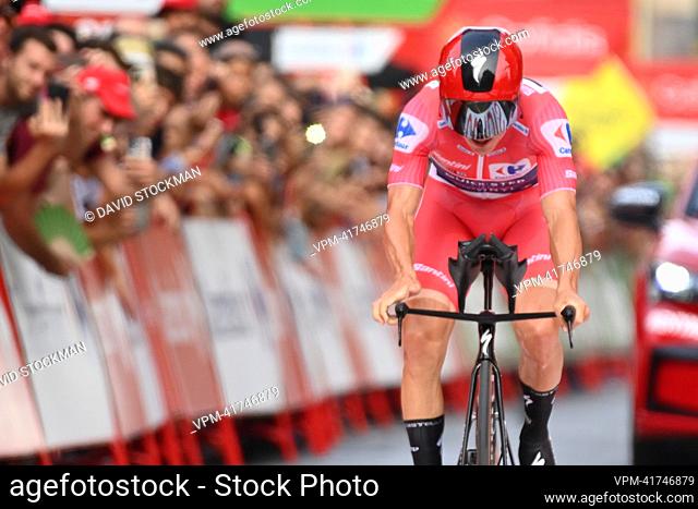 Belgian Remco Evenepoel of Quick-Step Alpha Vinyl wearing the red jersey for leader in the overall ranking crosses the finish line of stage 10 of the 2022...