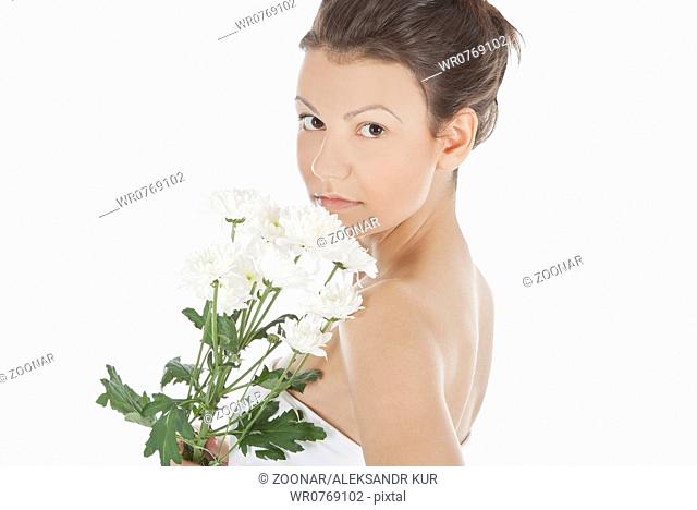 Beautiful portrait of a young sexy woman with a white flower