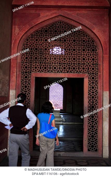 Tourist at Humayun's tomb built in 1570 made from red sandstone , Delhi , India UNESCO World Heritage Site