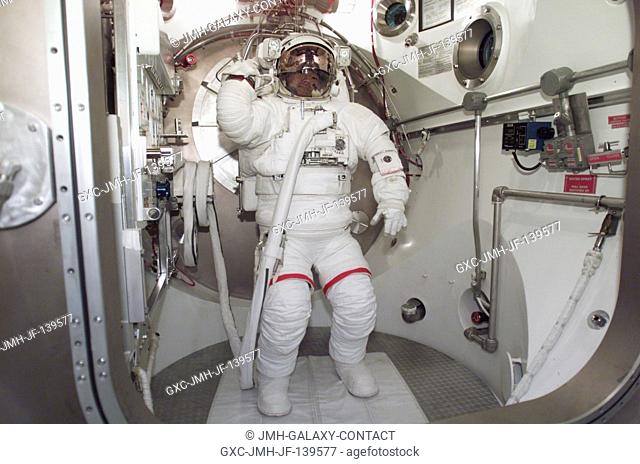 Astronaut Soichi Noguchi, STS-114 mission specialist, participates in an Extravehicular Mobility Unit (EMU) spacesuit fit check in the Space Station Airlock...