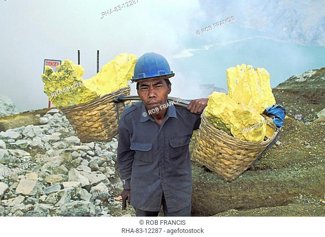 Man engaged in sulphur mining, a back-breaking and dangerous job in the Kawah Ijen Crater, Ijen Volcano, East Java, Indonesia, Southeast Asia, Asia