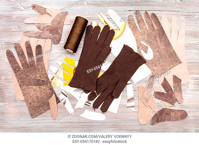 workshop on sewing gloves - top view of various objects for gloves production on wooden background