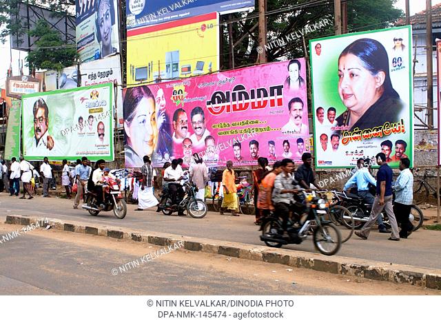 Hoardings depicting politicians and popular film stars at busy market street ; Mahatma Gandhi road ; Thanjavur ; Tamil Nadu ; India NO MR