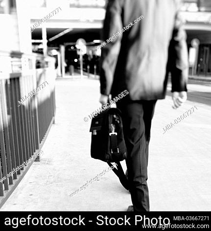 Businessman walks through city