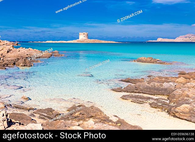 Stone tower on a beautiful turquoise blue mediterranean Pelosa beach near Stintino, Sardinia, Italy