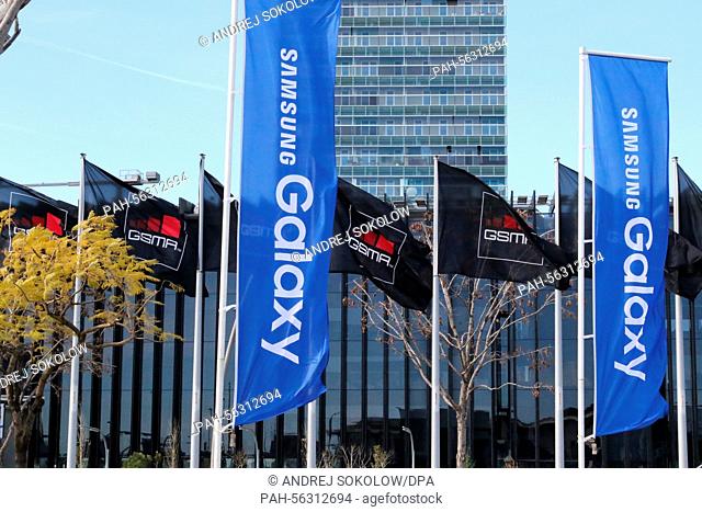 Flags of the exhibition organisers GSMA and smartphone manufacturer Samsung outside the exhibition centre before the Mobile World Congress in Barcelona, Spain