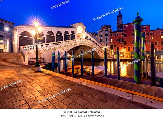 Famous Rialto Bridge or Ponte di Rialto over the Grand Canal in Venice during evening blue hour, Italy