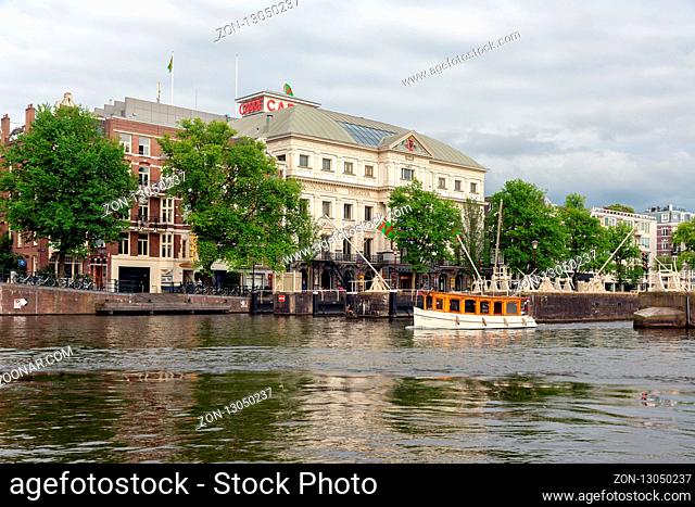 Amsterdam, The Netherlands - June 19, 2018: View from river Amstel at exterior of Royal Theater Carre, the official theatre of Amsterdam